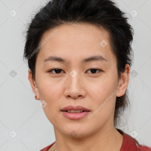 Joyful asian young-adult female with short  brown hair and brown eyes