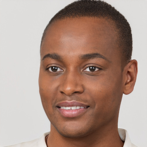 Joyful black young-adult male with short  brown hair and brown eyes