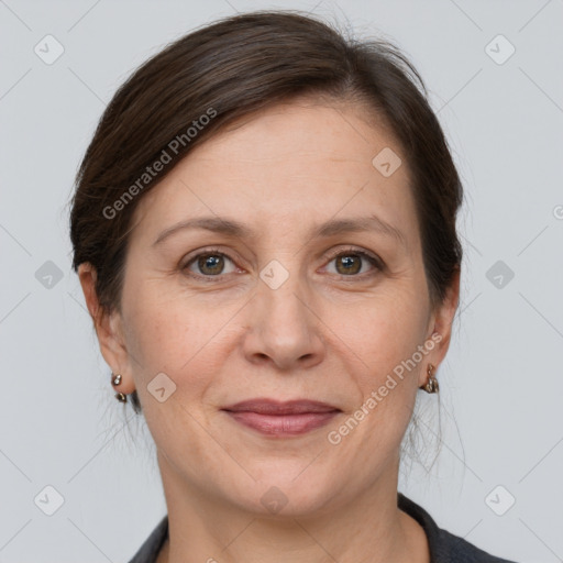 Joyful white adult female with medium  brown hair and grey eyes