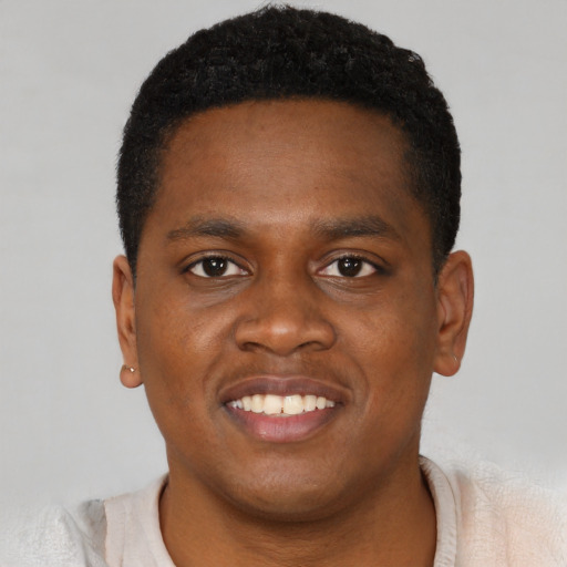 Joyful black young-adult male with short  brown hair and brown eyes
