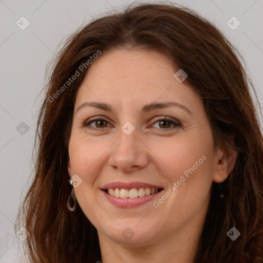 Joyful white adult female with long  brown hair and brown eyes