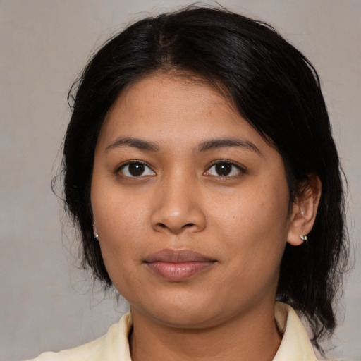 Joyful asian young-adult female with medium  black hair and brown eyes