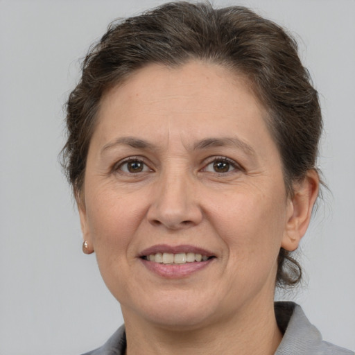 Joyful white adult female with medium  brown hair and brown eyes