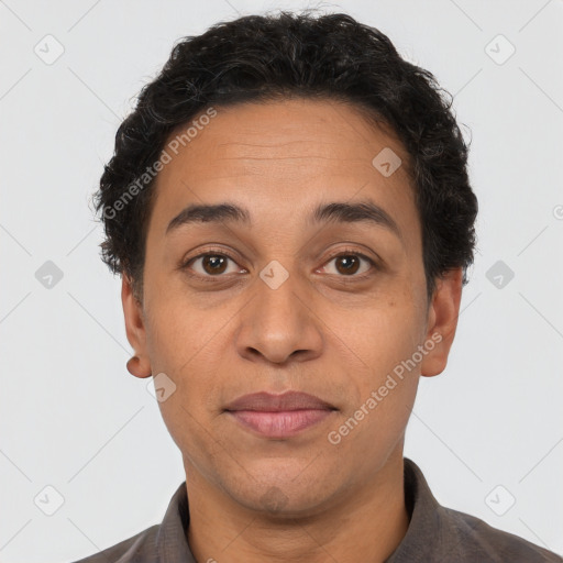 Joyful latino adult male with short  brown hair and brown eyes