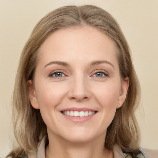 Joyful white young-adult female with medium  brown hair and grey eyes