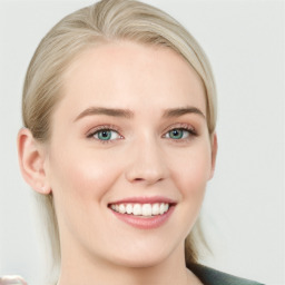 Joyful white young-adult female with long  brown hair and blue eyes