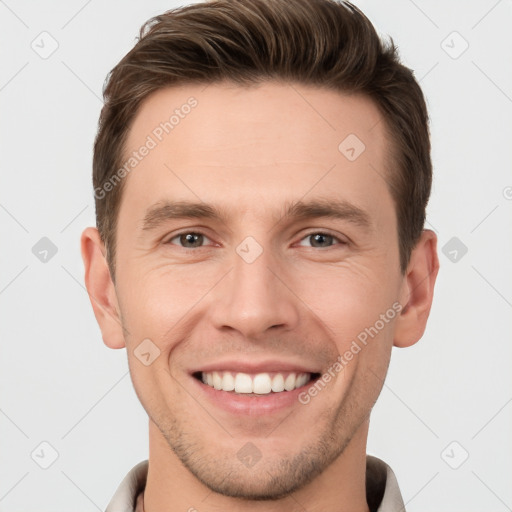 Joyful white young-adult male with short  brown hair and grey eyes