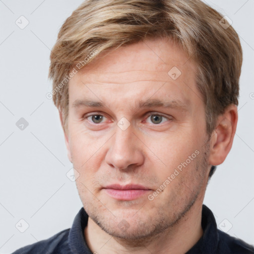 Joyful white adult male with short  brown hair and grey eyes