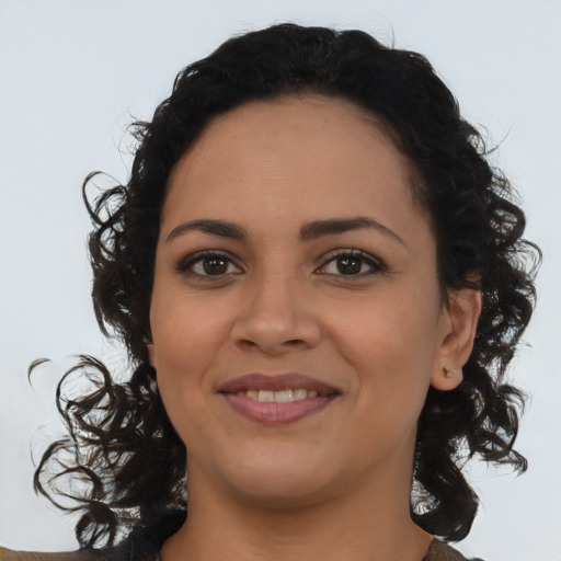 Joyful latino young-adult female with long  brown hair and brown eyes