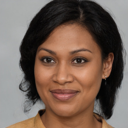 Joyful black young-adult female with medium  brown hair and brown eyes