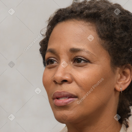 Joyful black adult female with short  brown hair and brown eyes