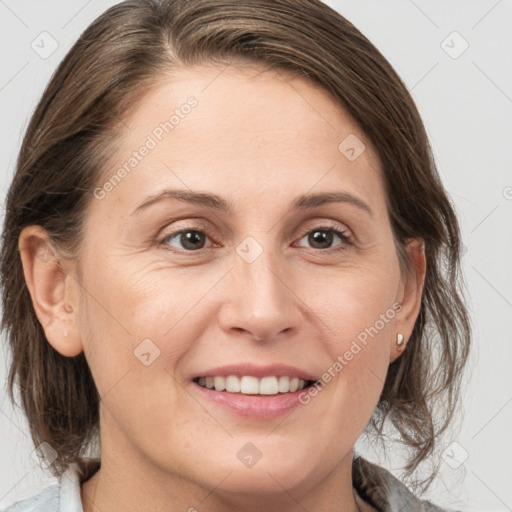 Joyful white adult female with medium  brown hair and grey eyes