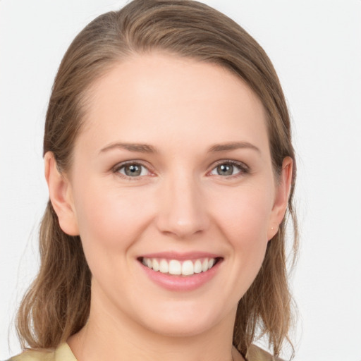 Joyful white young-adult female with medium  brown hair and grey eyes