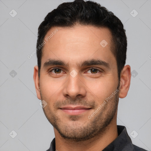 Joyful white young-adult male with short  black hair and brown eyes