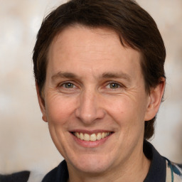 Joyful white adult male with medium  brown hair and brown eyes