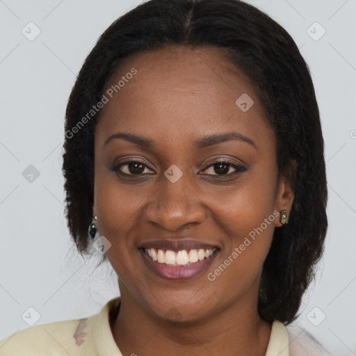 Joyful black young-adult female with long  brown hair and brown eyes