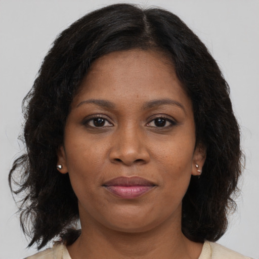 Joyful black young-adult female with medium  brown hair and brown eyes