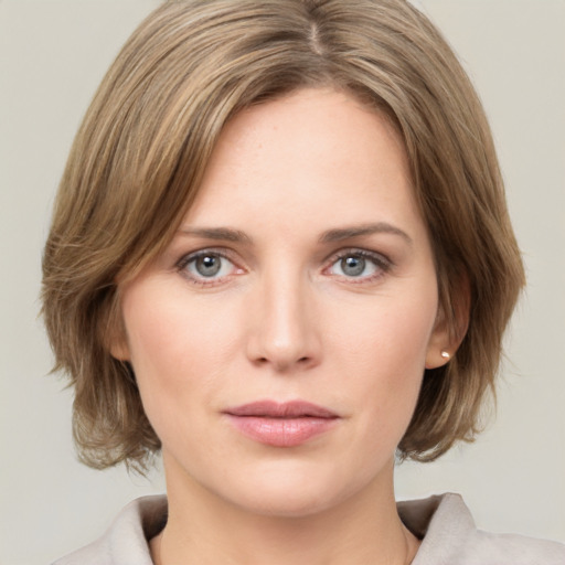 Joyful white young-adult female with medium  brown hair and green eyes