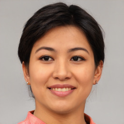 Joyful asian young-adult female with medium  brown hair and brown eyes