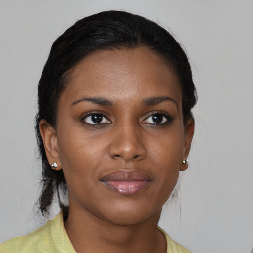 Joyful black young-adult female with medium  brown hair and brown eyes