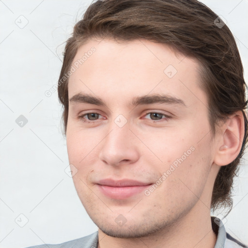 Joyful white young-adult male with medium  brown hair and brown eyes