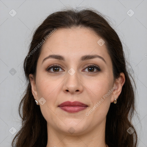 Joyful white adult female with long  brown hair and grey eyes