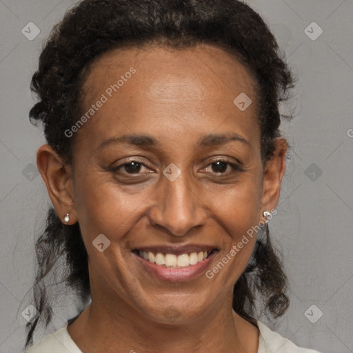 Joyful black adult female with short  brown hair and brown eyes