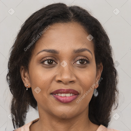 Joyful black adult female with medium  brown hair and brown eyes