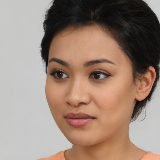Joyful latino young-adult female with medium  black hair and brown eyes