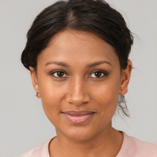 Joyful black young-adult female with short  brown hair and brown eyes