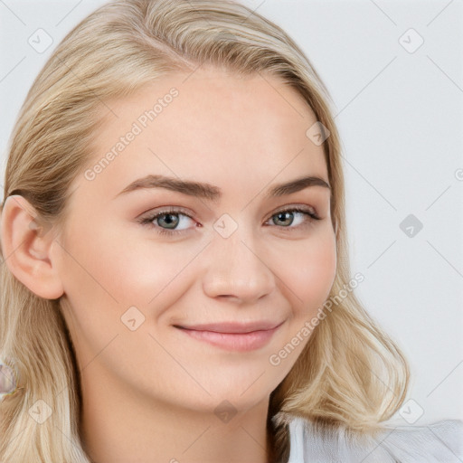 Joyful white young-adult female with long  brown hair and blue eyes