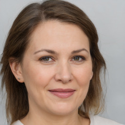 Joyful white adult female with medium  brown hair and brown eyes