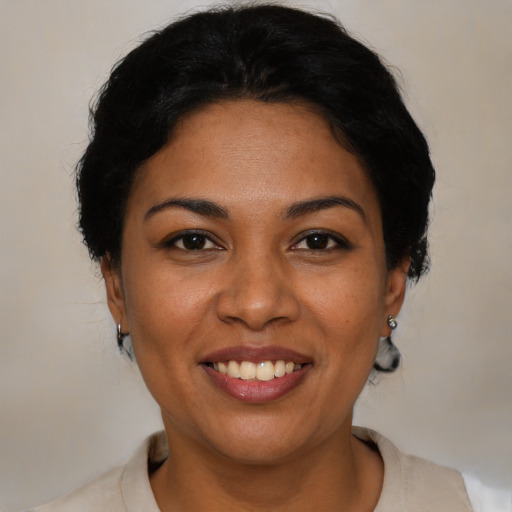 Joyful latino adult female with short  brown hair and brown eyes