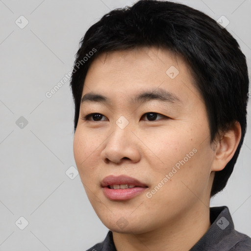 Joyful asian young-adult male with short  black hair and brown eyes