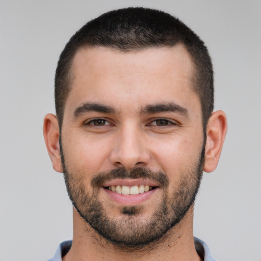 Joyful white young-adult male with short  brown hair and brown eyes