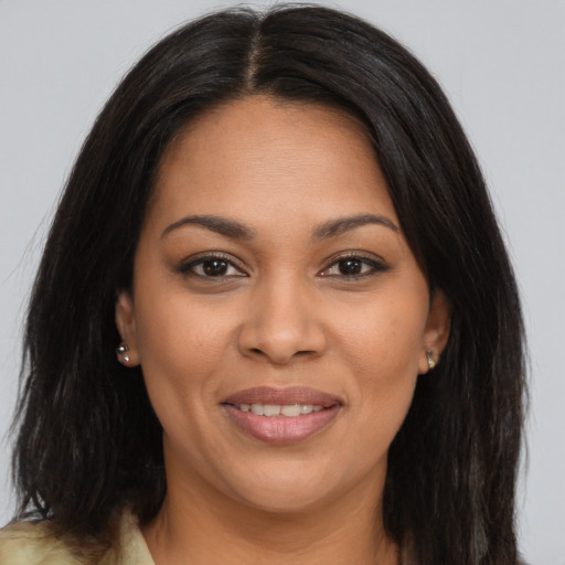 Joyful latino young-adult female with long  brown hair and brown eyes