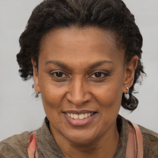 Joyful black adult female with short  brown hair and brown eyes