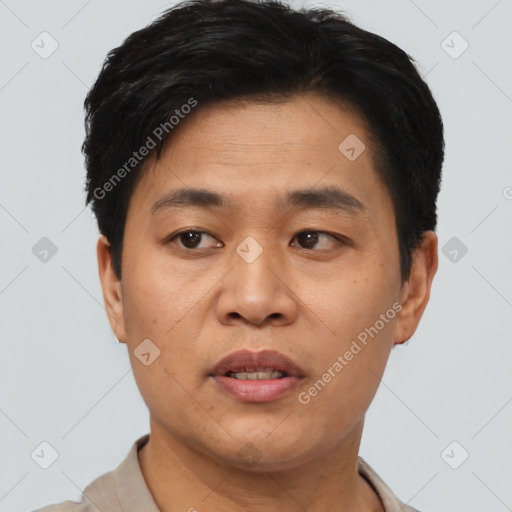 Joyful asian young-adult male with short  black hair and brown eyes