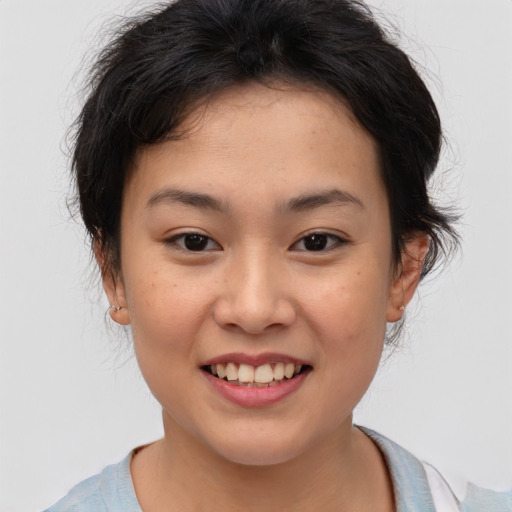 Joyful asian young-adult female with medium  brown hair and brown eyes