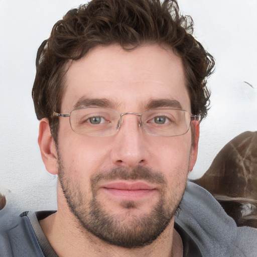 Joyful white young-adult male with short  brown hair and blue eyes