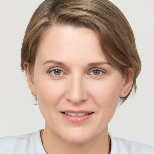 Joyful white young-adult female with medium  brown hair and blue eyes