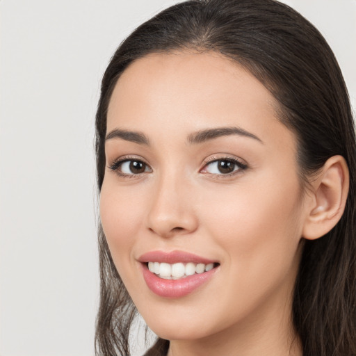 Joyful white young-adult female with long  brown hair and brown eyes