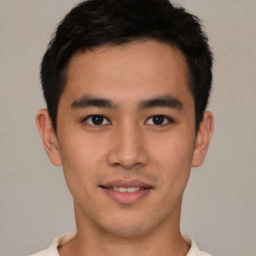 Joyful latino young-adult male with short  brown hair and brown eyes