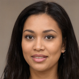 Joyful latino young-adult female with long  brown hair and brown eyes