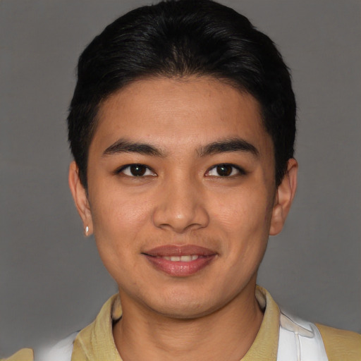 Joyful latino young-adult male with short  brown hair and brown eyes
