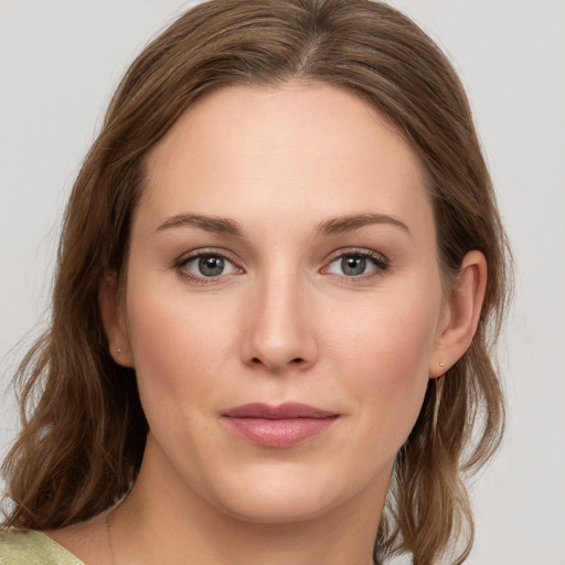 Joyful white young-adult female with medium  brown hair and green eyes