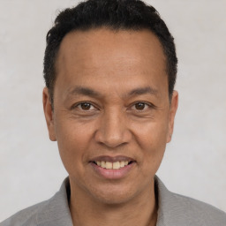 Joyful white adult male with short  black hair and brown eyes