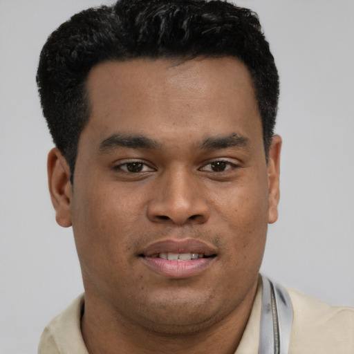 Joyful latino young-adult male with short  brown hair and brown eyes