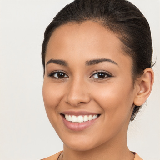 Joyful white young-adult female with long  brown hair and brown eyes