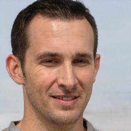 Joyful white adult male with short  brown hair and brown eyes